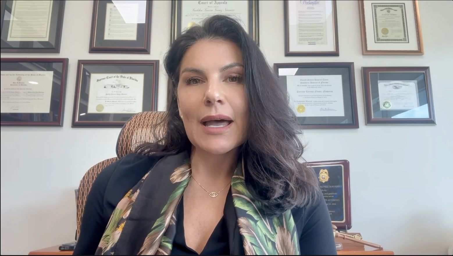 Expert recording video commentary from an office with certificates